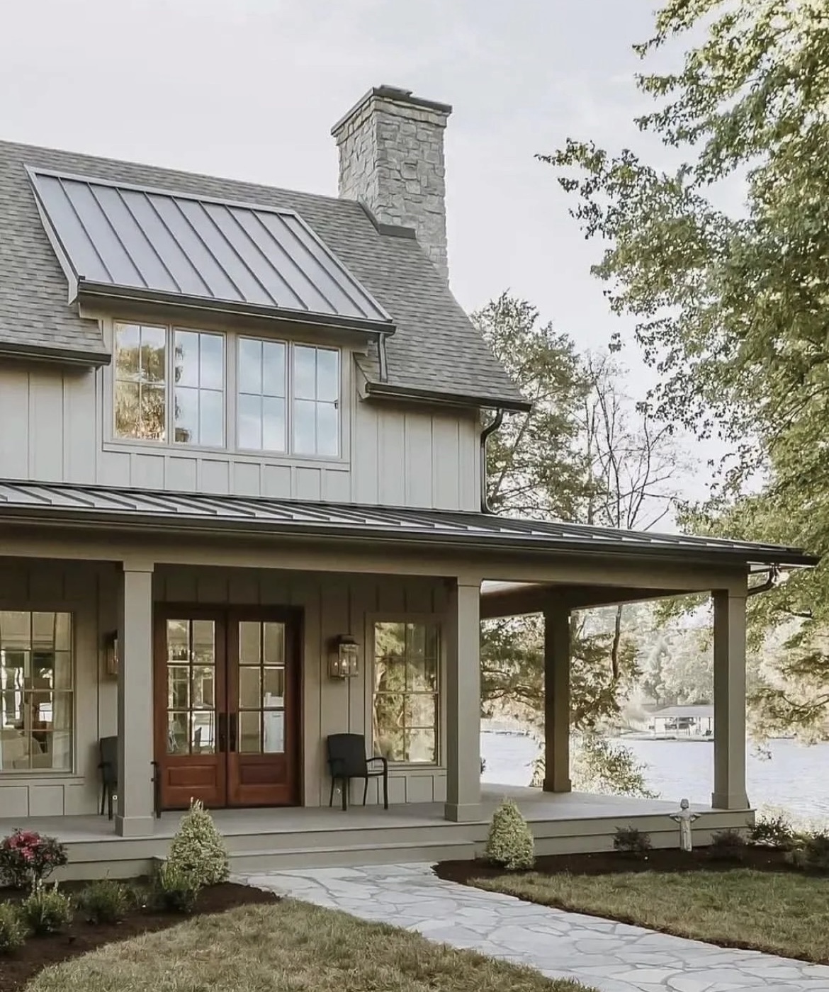 Beautiful modern home exterior with wooden doors and wraparound porch